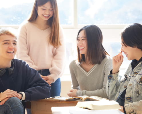 本を広げた数人の人物